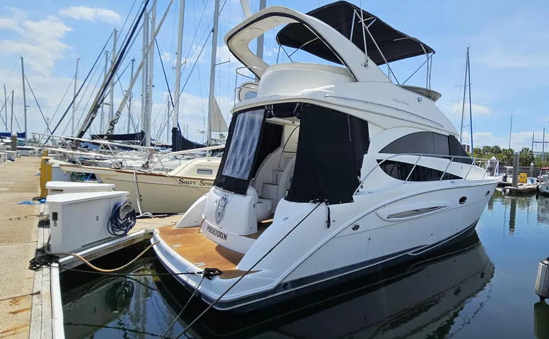 The Image of 2007 Meridian 341 Sedan yacht docked at marina with sailboats in background. - 0