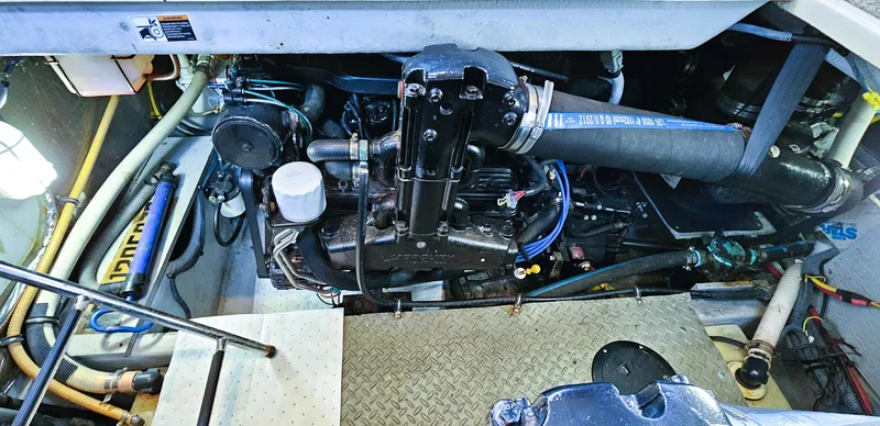 Slide: The Image of Engine compartment of a 2007 Meridian 341 Sedan boat, showcasing mechanical components and hoses. - 20