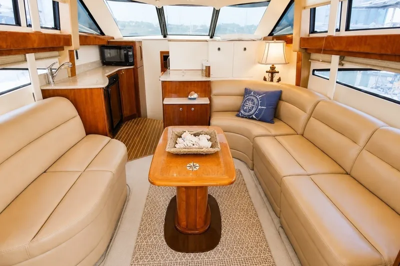Slide: The Image of Luxurious interior of 2007 Meridian 341 Sedan yacht with beige leather seating and wooden accents. - 3