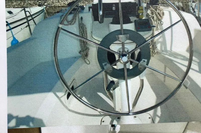 Slide: The Image of Steering wheel of a 2003 Hunter 306 sailboat, showcasing cockpit details. - 10