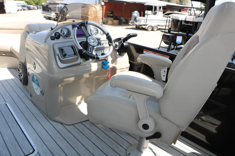 Slide: The Image of Captain's chair and helm of 2019 Trifecta 23RF SS Arch boat, featuring modern controls. - 32