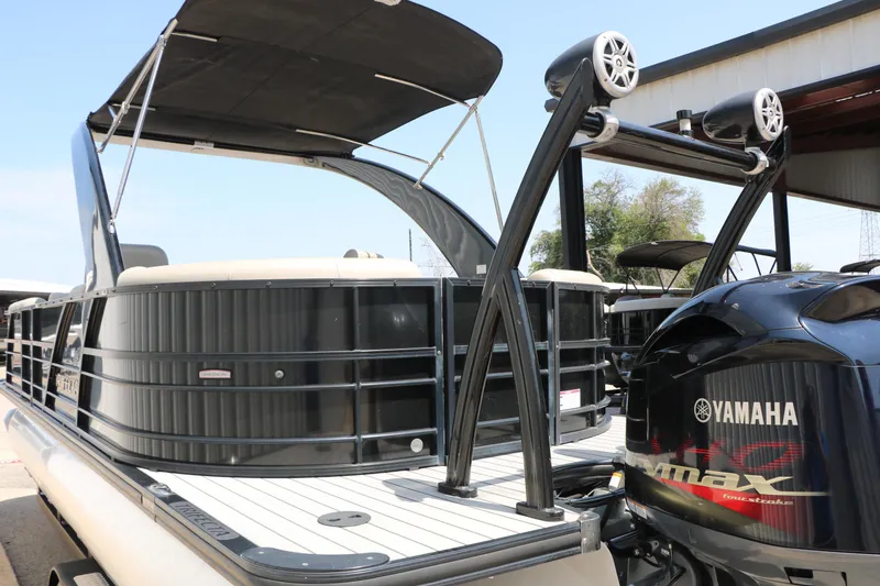 Slide: The Image of 2019 Trifecta 23RF SS Arch pontoon boat with Yamaha engine, docked under a canopy. - 10
