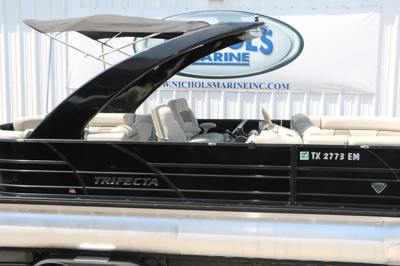 Slide: The Image of 2019 Trifecta 23RF SS Arch pontoon boat with sleek black design and canopy. - 13