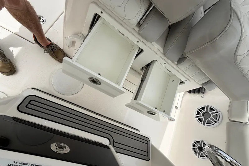 Slide: The Image of 2022 Sea Fox 288 Commander boat interior with open storage compartments and seating. - 24