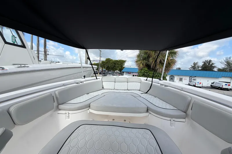 Slide: The Image of 2022 Sea Fox 288 Commander boat interior with cushioned seating under canopy. - 56