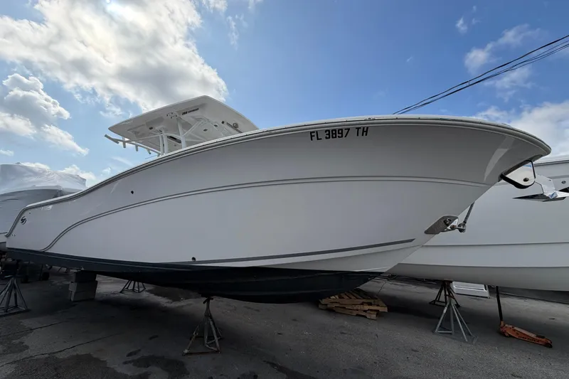 The Image of 2022 Sea Fox 288 Commander boat on stands under a partly cloudy sky. - 0