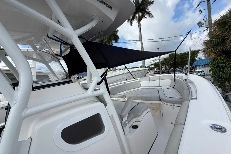 Slide: The Image of 2022 Sea Fox 288 Commander boat interior with seating and canopy, docked outdoors. - 55