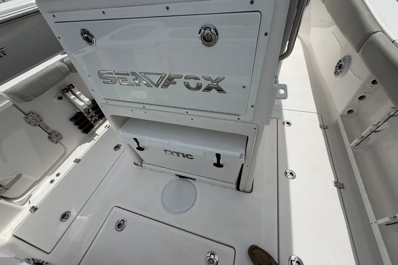 Slide: The Image of 2022 Sea Fox 288 Commander boat interior with storage compartments and RTIC cooler. - 29