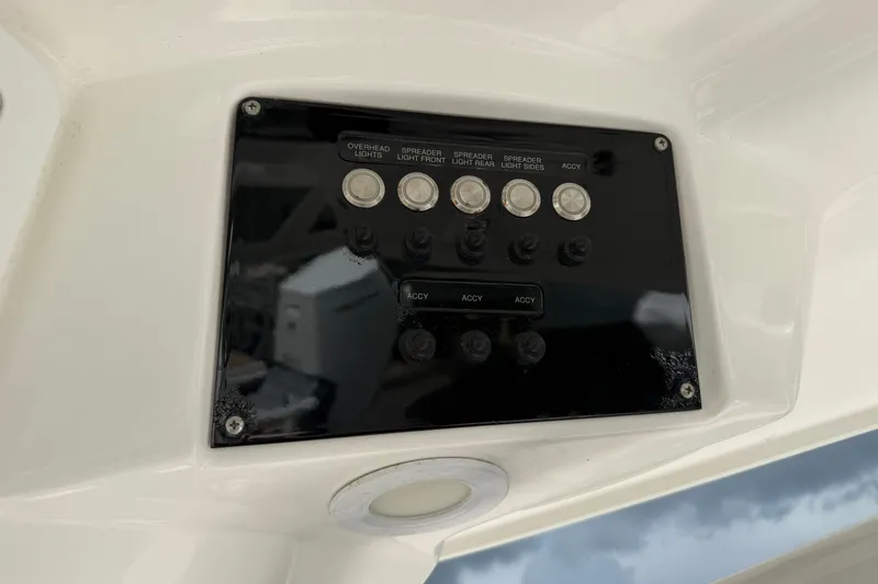 Slide: The Image of Control panel on a 2022 Sea Fox 288 Commander boat, featuring various light switches. - 19