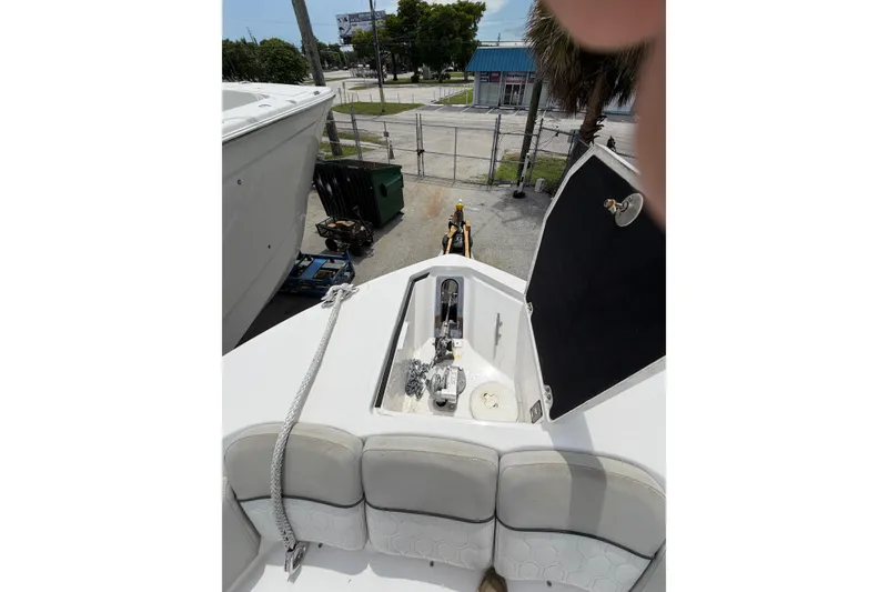 Slide: The Image of 2022 Sea Fox 288 Commander boat deck with open storage compartment and rope. - 38