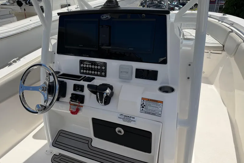 Slide: The Image of 2022 Sea Fox 288 Commander boat dashboard with steering wheel and electronic controls. - 49