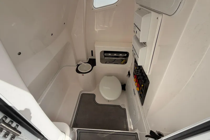 Slide: The Image of Interior of 2022 Sea Fox 288 Commander boat featuring a compact marine toilet and control panel. - 53