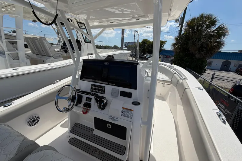 Slide: The Image of 2022 Sea Fox 288 Commander boat interior with steering wheel and control panel. - 48