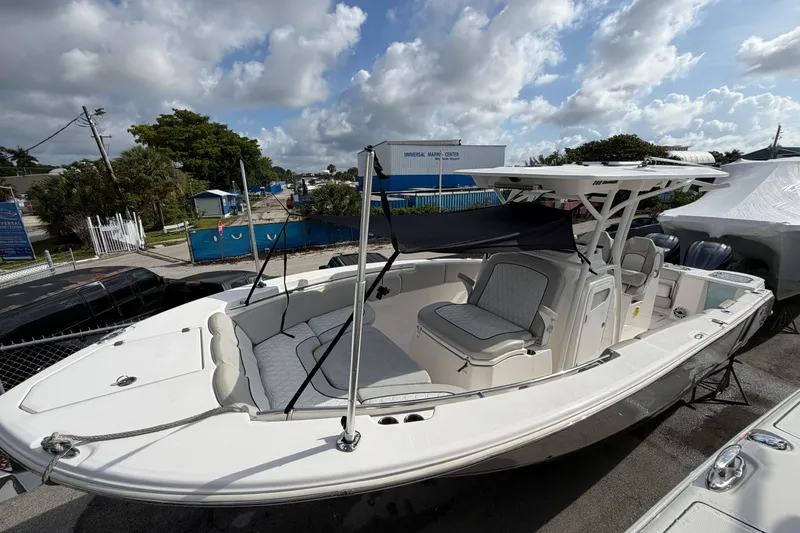 Slide: The Image of 2022 Sea Fox 288 Commander boat with spacious seating, docked under a cloudy sky. - 57
