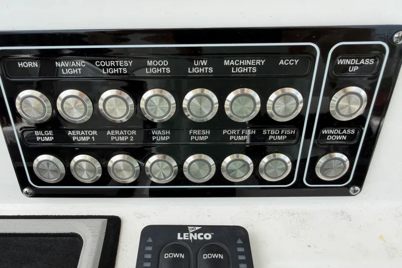 Slide: The Image of Control panel of a 2022 Sea Fox 288 Commander boat with various switches. - 43