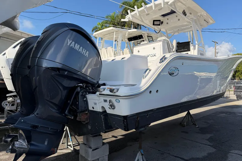 Slide: The Image of 2022 Sea Fox 288 Commander boat with Yamaha engines, displayed on stands. - 52