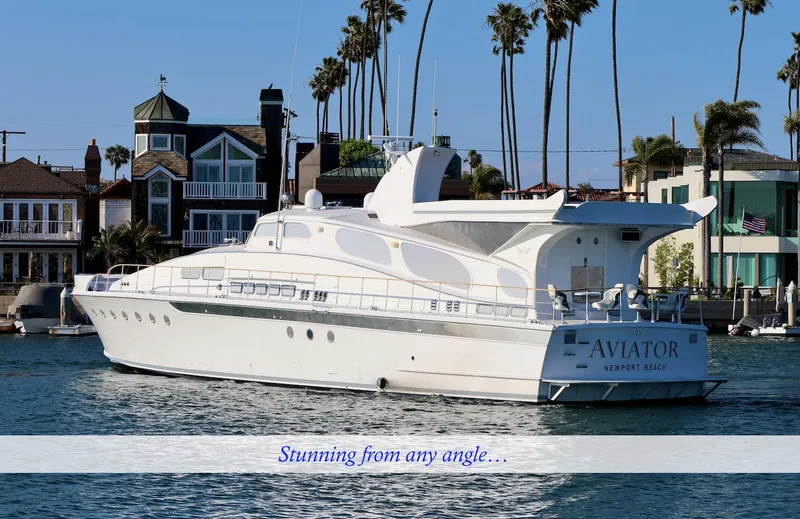 Slide: The Image of Elegant 1945 custom motor yacht near coastal homes. - 2