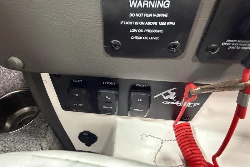 Slide: The Image of Control panel of a 2010 Moomba LSV boat with ballast fill switches. - 12
