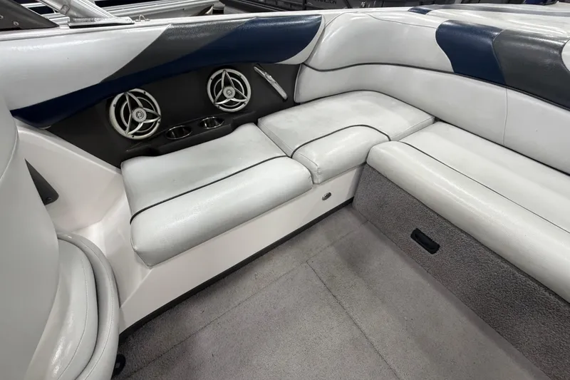Slide: The Image of Interior of a 2010 Moomba LSV boat with white seating and built-in speakers. - 7
