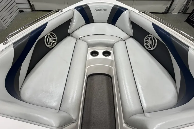 Slide: The Image of Interior of a 2010 Moomba LSV boat with gray and blue seating. - 13
