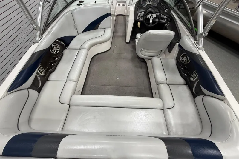 Slide: The Image of 2010 Moomba LSV boat interior with white and blue seating, steering wheel, and dashboard. - 3