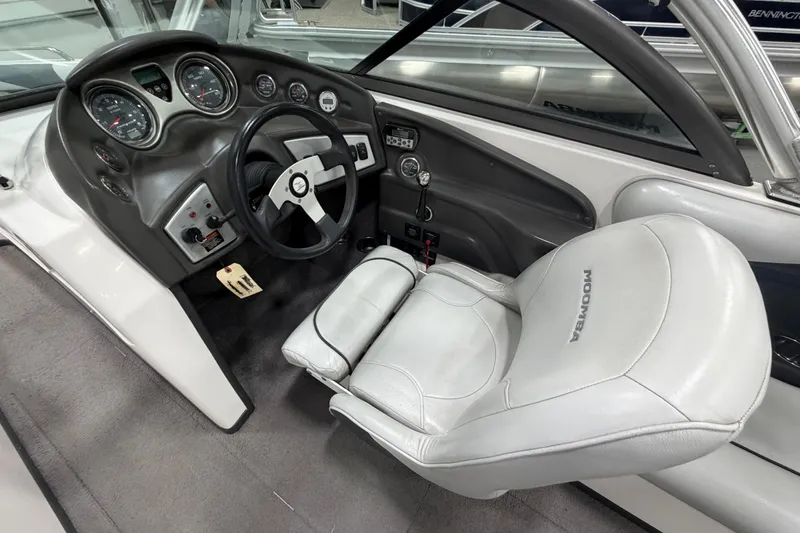 Slide: The Image of 2010 Moomba LSV boat interior with steering wheel and dashboard controls. - 11