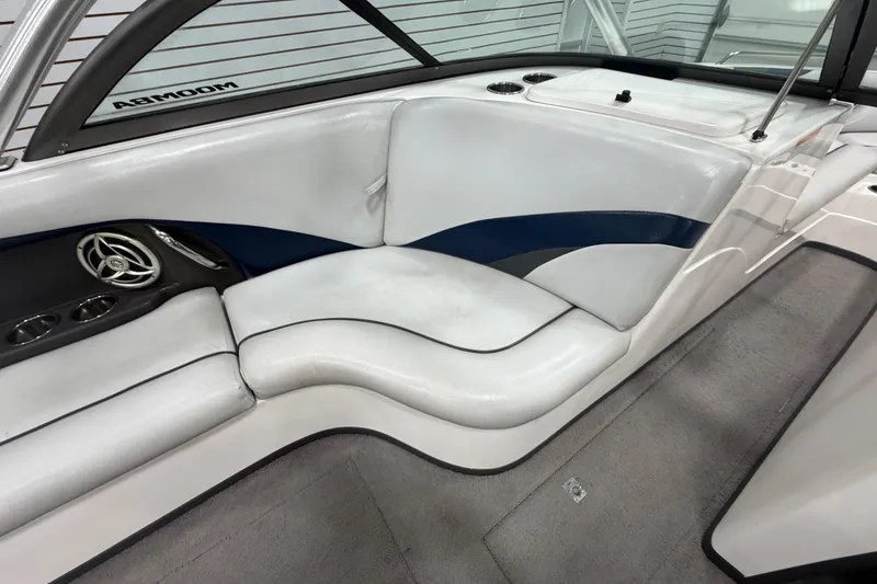 Slide: The Image of Interior of a 2010 Moomba LSV boat with white and blue seating. - 10