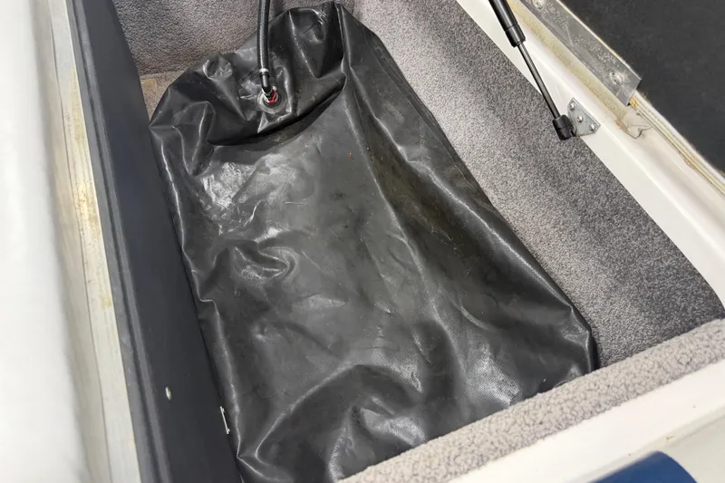 Slide: The Image of 2010 Moomba LSV boat storage compartment with black liner and hydraulic lift. - 14