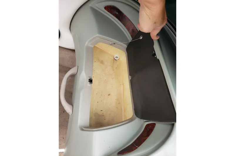 Slide: The Image of Open storage compartment in 1998 Chaparral 2130 SS boat, showcasing interior details. - 14