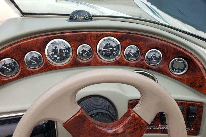 Slide: The Image of Dashboard of a 1998 Chaparral 2130 SS boat with wood paneling and gauges. - 8