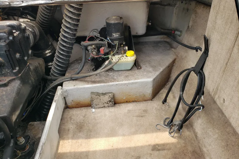 Slide: The Image of Engine compartment of a 1998 Chaparral 2130 SS boat, showing mechanical components and wiring. - 20