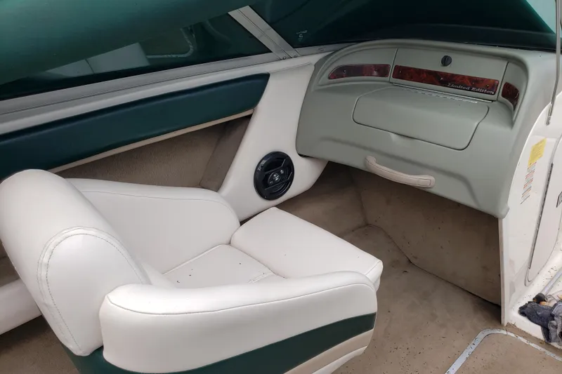Slide: The Image of Interior of a 1998 Chaparral 2130 SS boat with white seating and dashboard. - 12