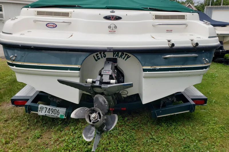 Slide: The Image of 1998 Chaparral 2130 SS boat with "Let's Party" text, parked on grass. - 3