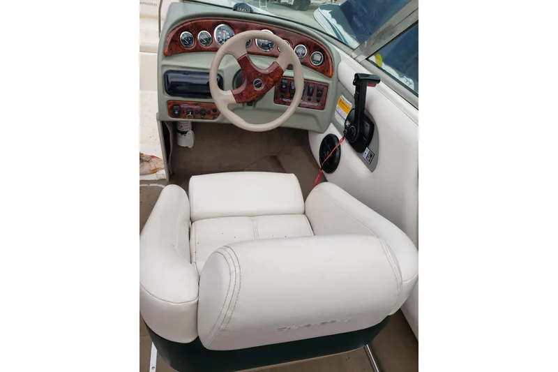 Slide: The Image of Interior of a 1998 Chaparral 2130 SS boat, featuring a steering wheel and dashboard controls. - 10