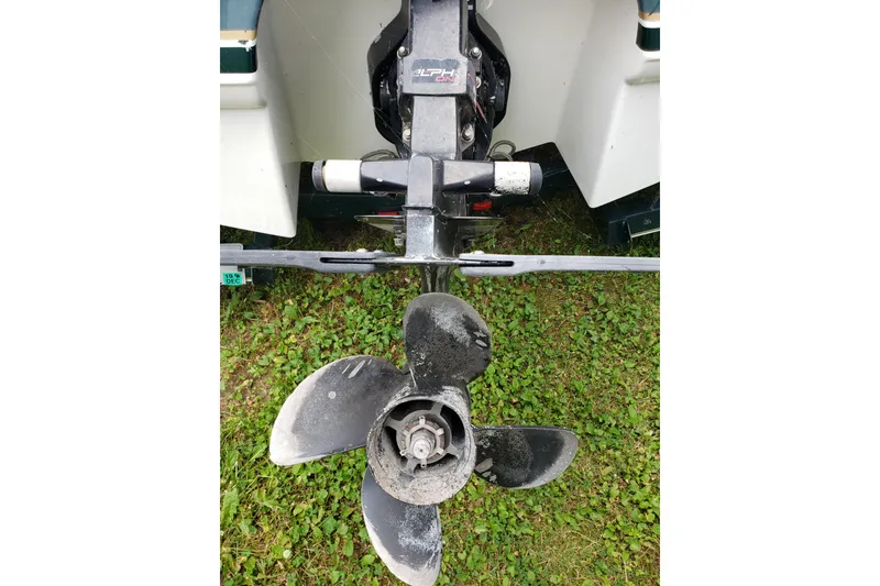 Slide: The Image of 1998 Chaparral 2130 SS boat propeller on grass, showing wear and detail. - 4