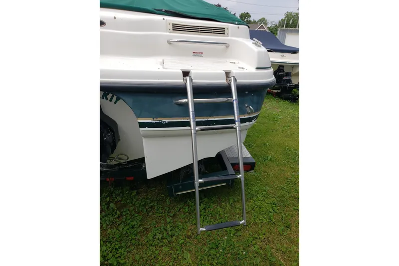Slide: The Image of 1998 Chaparral 2130 SS boat with extended swim ladder on grassy area. - 7