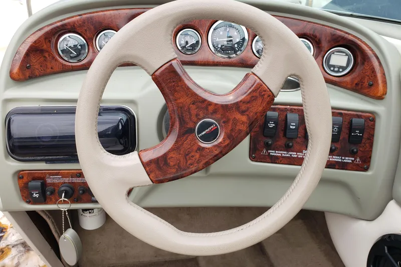 Slide: The Image of Dashboard of a 1998 Chaparral 2130 SS boat with wood accents and gauges. - 9