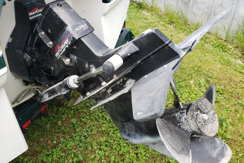 Slide: The Image of Outboard motor of a 1998 Chaparral 2130 SS boat on grassy ground. - 6