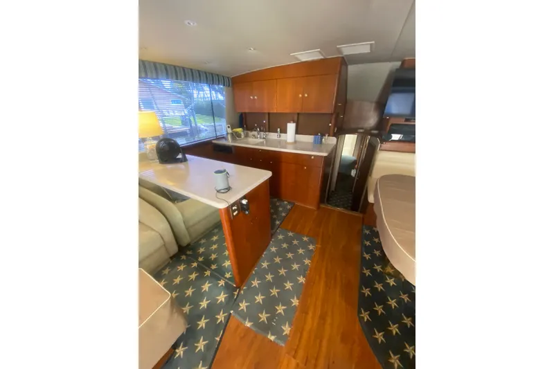 Slide: The Image of Interior of 1996 Ocean Super Sport yacht with wood cabinetry and star-patterned carpet. - 11