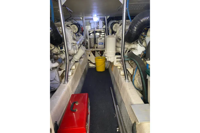 Slide: The Image of Engine room of a 1996 Ocean Super Sport boat, featuring machinery and tools. - 20