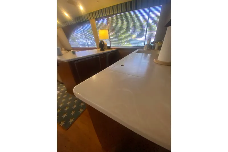 Slide: The Image of Interior of 1996 Ocean Super Sport yacht with modern kitchen and large windows. - 16
