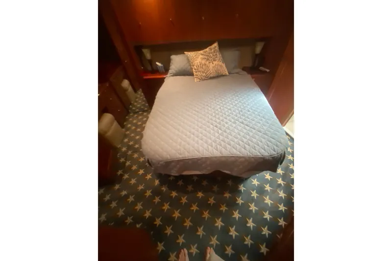 Slide: The Image of Cozy bedroom in 1996 Ocean Super Sport yacht with star-patterned carpet and quilted bedding. - 13