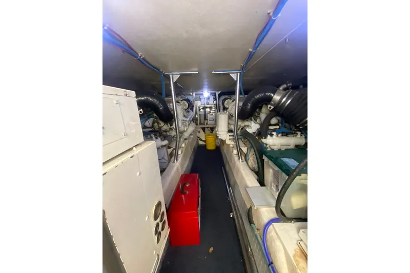 Slide: The Image of Engine room of a 1996 Ocean Super Sport boat, showcasing machinery and equipment. - 19