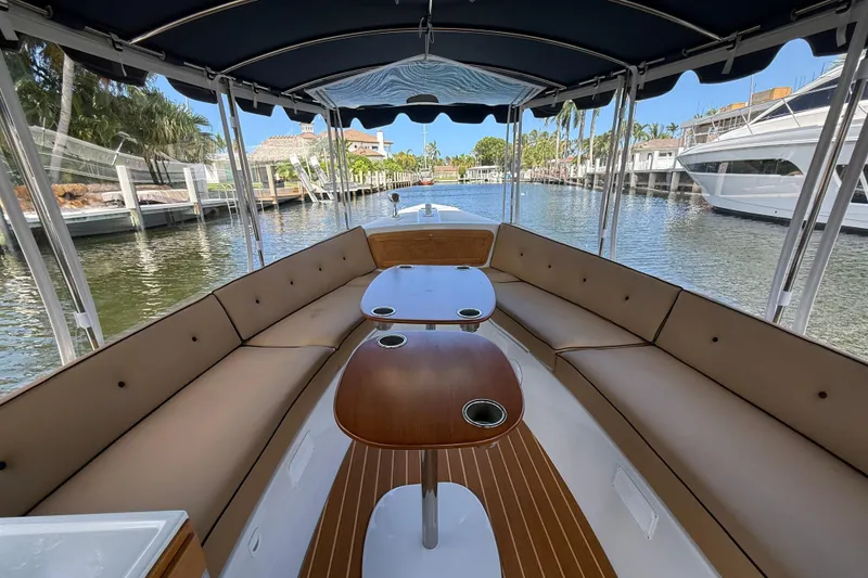 Slide: The Image of Interior view of 2021 Duffy Bay Island 22 boat with spacious seating and tables. - 8