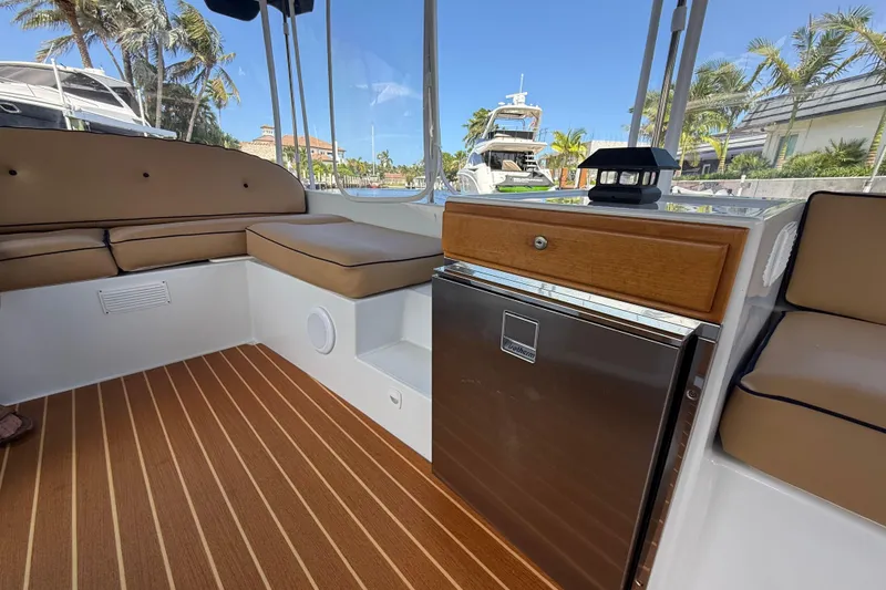 Slide: The Image of Interior of 2021 Duffy Bay Island 22 boat with seating and mini fridge. - 14