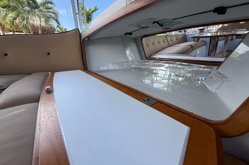 Slide: The Image of Interior of a 2021 Duffy Bay Island 22 boat, featuring elegant seating and wooden accents. - 13