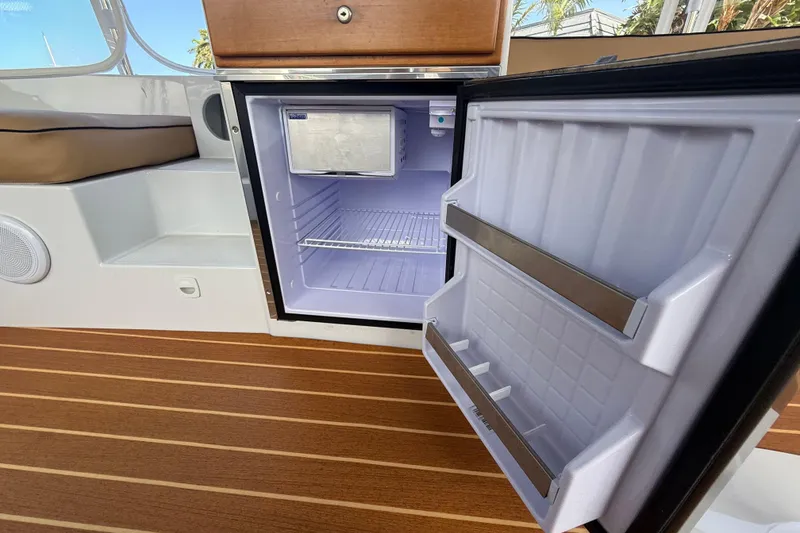 Slide: The Image of Open fridge on 2021 Duffy Bay Island 22 boat with wooden flooring. - 15