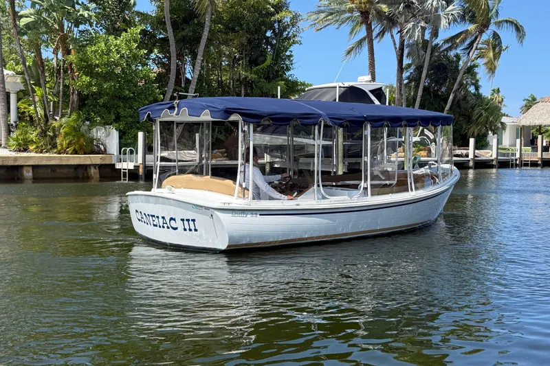 Slide: The Image of 2021 Duffy Bay Island 22 boat with canopy cruising on a scenic waterway. - 3