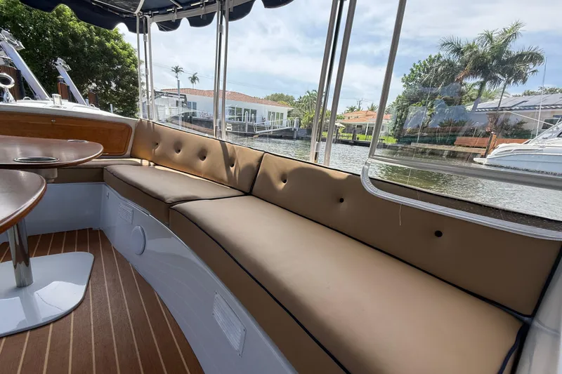 Slide: The Image of Interior of 2021 Duffy Bay Island 22 boat with cushioned seating and waterfront view. - 10