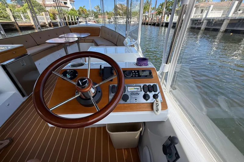 Slide: The Image of Steering console of a 2021 Duffy Bay Island 22 boat on a scenic waterway. - 16